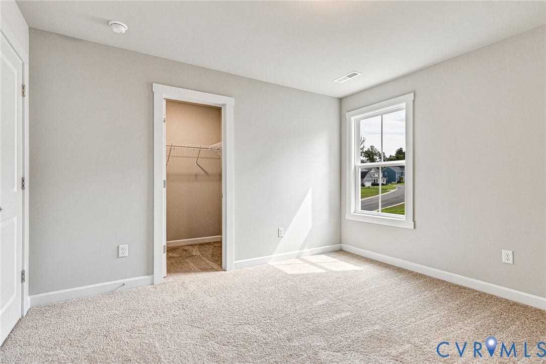Neutral wall color, wall-to-wall carpeting, white trim work, single window, and wire shelving in the closet