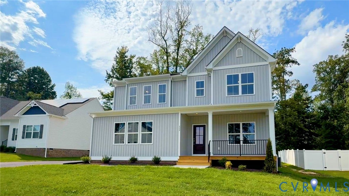 Two-story residence with a covered porch and light gray vertical siding