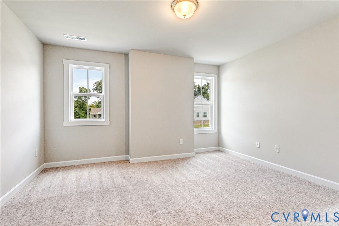 Neutral wall paint, carpet flooring, and white trim