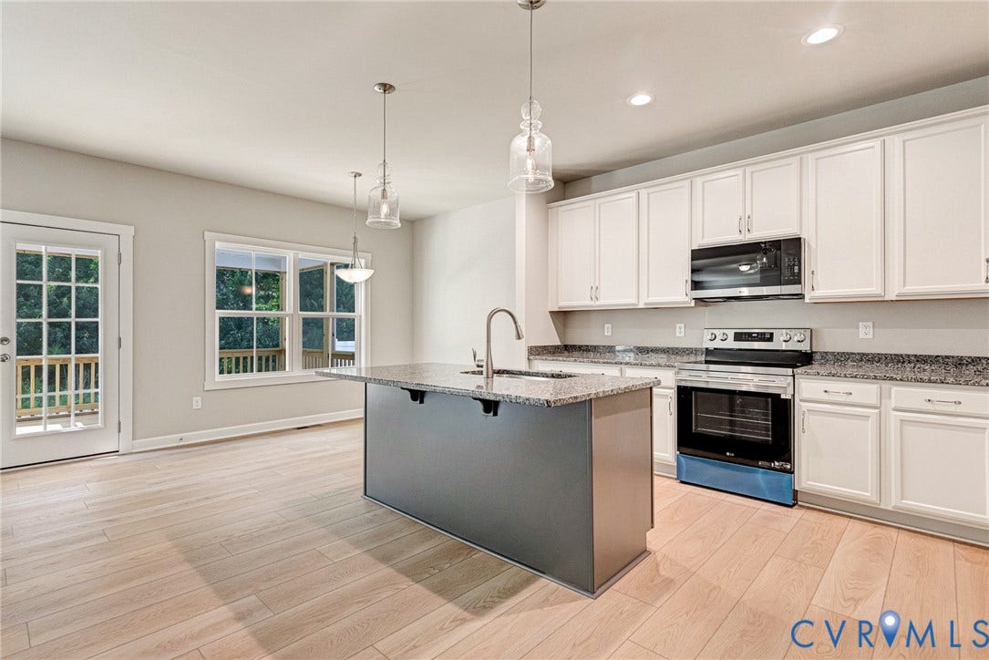 Kitchen island with granite countertop and stainless steel sink