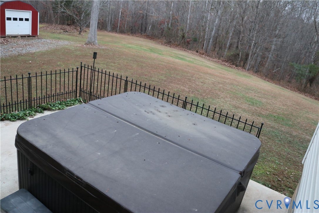 128 Quarry, Quarry, Cumberland, VA 23040 Wooden terrace featuring a hot tub and a forest view