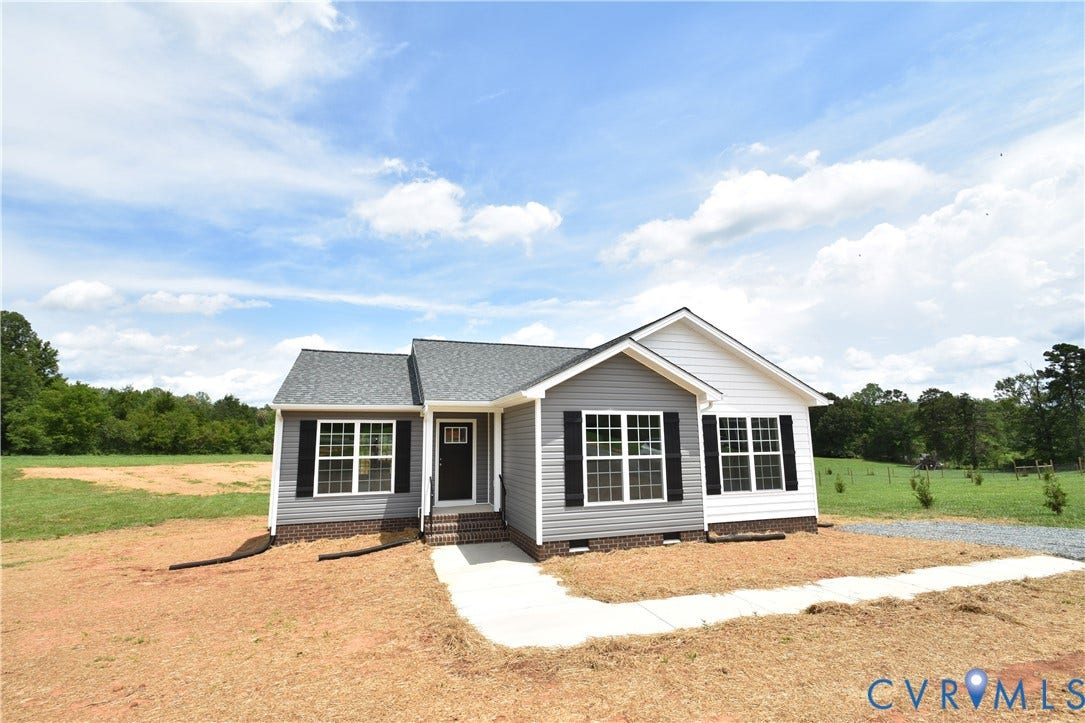 Exterior showcasing gray and white siding, dark shutters, and a gray shingle roof