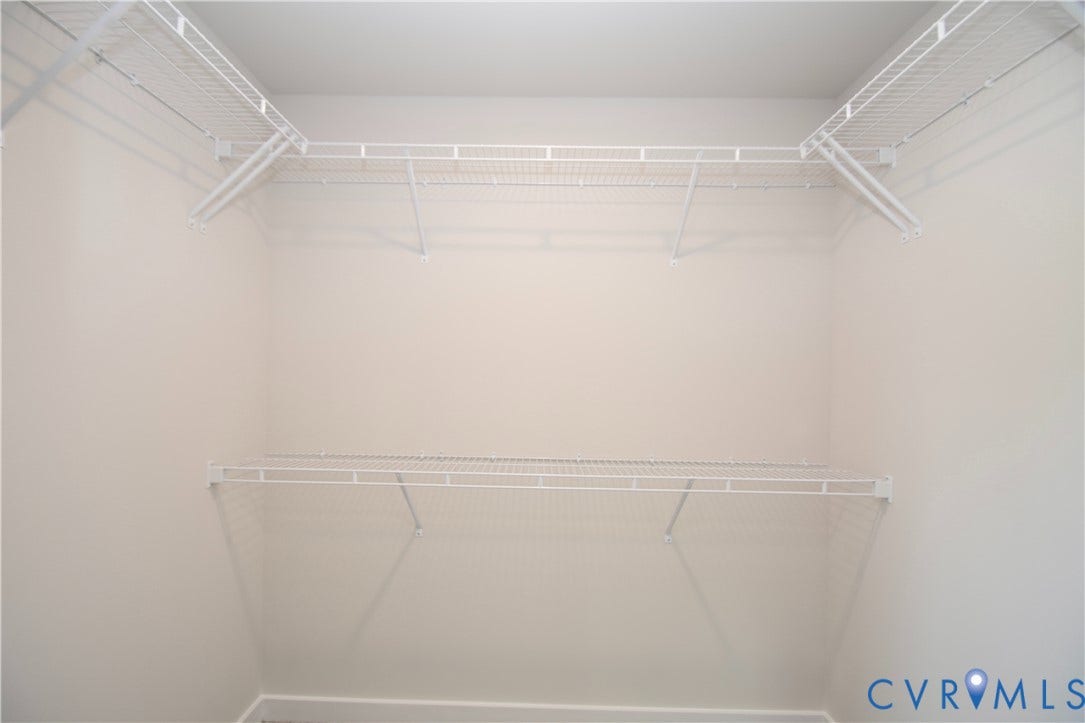 Walk-in closet featuring white wire shelving