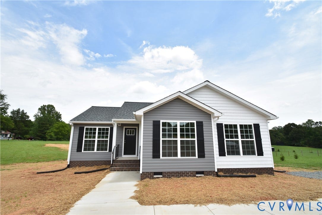 Contemporary ranch-style home featuring a two-tone siding facade, dark shingle roof, white trim, and black shutters