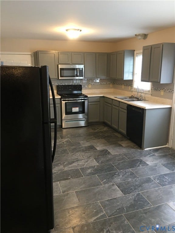 5104 Highberry Woods Road, Richmond, VA 23112 Kitchen featuring gray cabinets, black appliances, light countertops, and backsplash