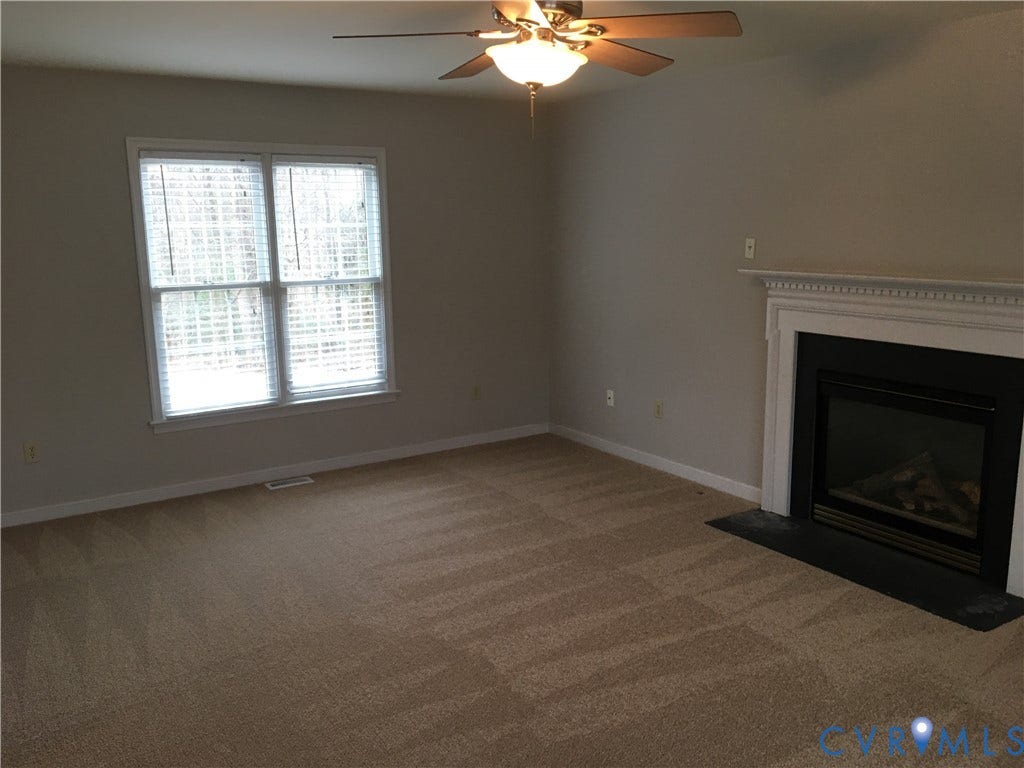 5104 Highberry Woods Road, Richmond, VA 23112 Unfurnished living room with light carpet, ceiling fan, and a fireplace with flush hearth