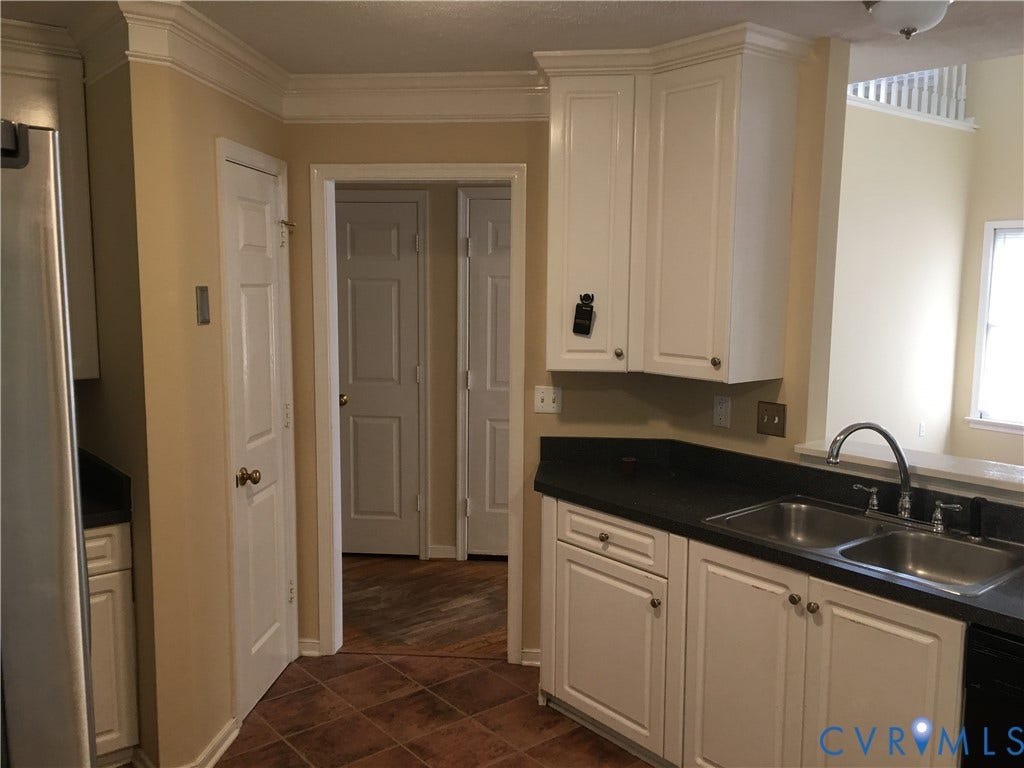 5104 Highberry Woods Road, Richmond, VA 23112 Kitchen featuring dark countertops, white cabinets, dark tile patterned floors, black dishwasher, and ornamental molding