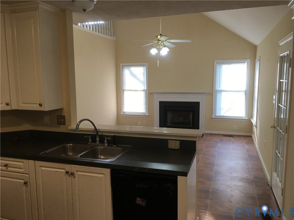 5104 Highberry Woods Road, Richmond, VA 23112 Kitchen with dark countertops, dishwasher, vaulted ceiling, healthy amount of natural light, and a fireplace