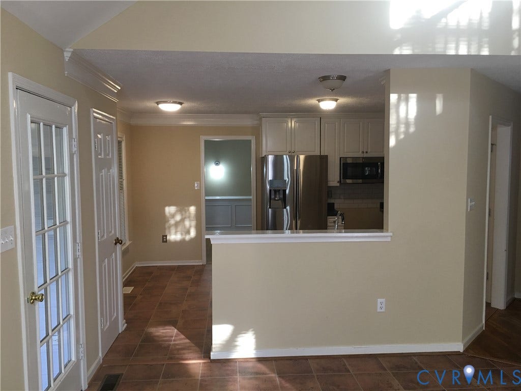 5104 Highberry Woods Road, Richmond, VA 23112 Kitchen featuring stainless steel appliances, dark tile patterned floors, light countertops, backsplash, and crown molding