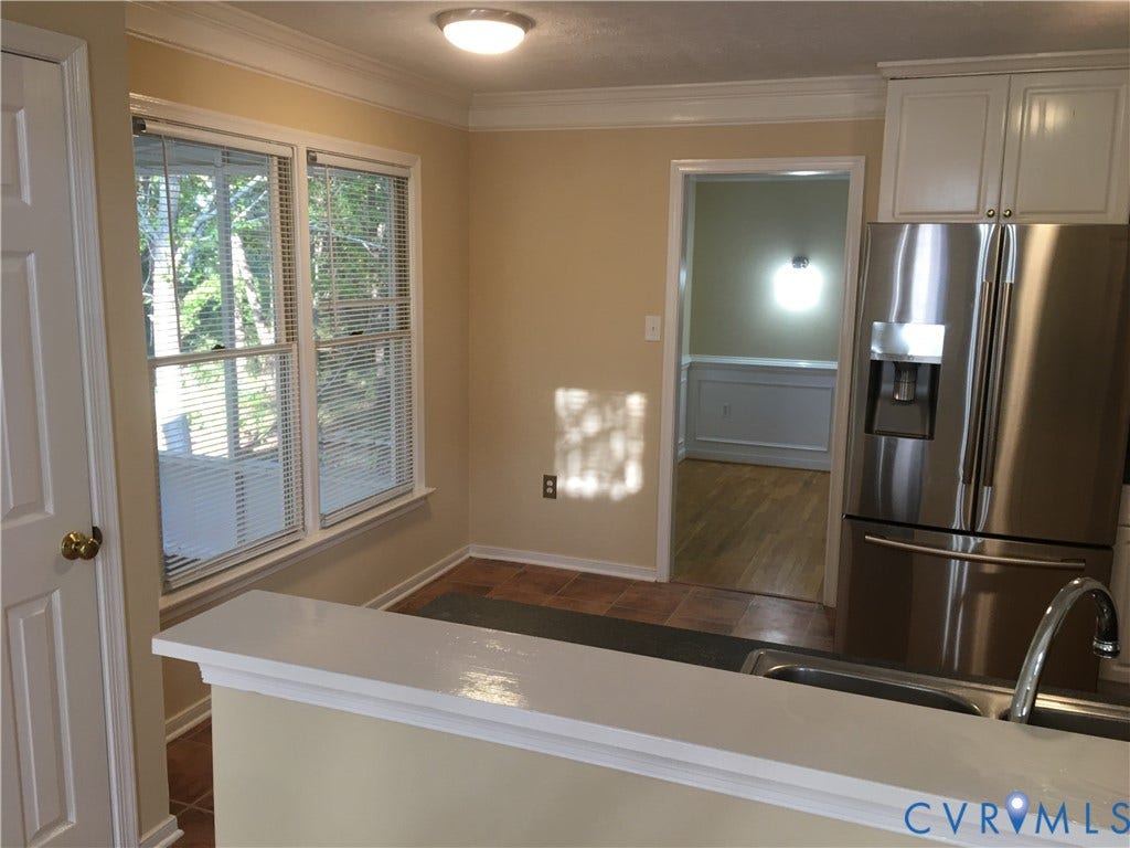 5104 Highberry Woods Road, Richmond, VA 23112 Kitchen featuring stainless steel fridge, ornamental molding, light countertops, and white cabinetry