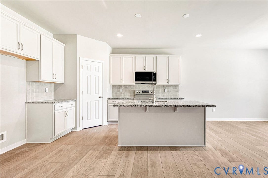 11105 Somerset Bluff Court, Somerset Hills, Glen Allen, VA 23059 Kitchen featuring white cabinetry, light wood-finish flooring, a central island with a sink, tiled backsplash, and recessed lighting