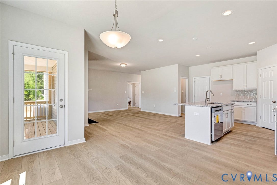 11105 Somerset Bluff Court, Somerset Hills, Glen Allen, VA 23059 Open-concept living space with wood-finish flooring, recessed lighting, and a kitchen island featuring a stainless steel sink and dishwasher