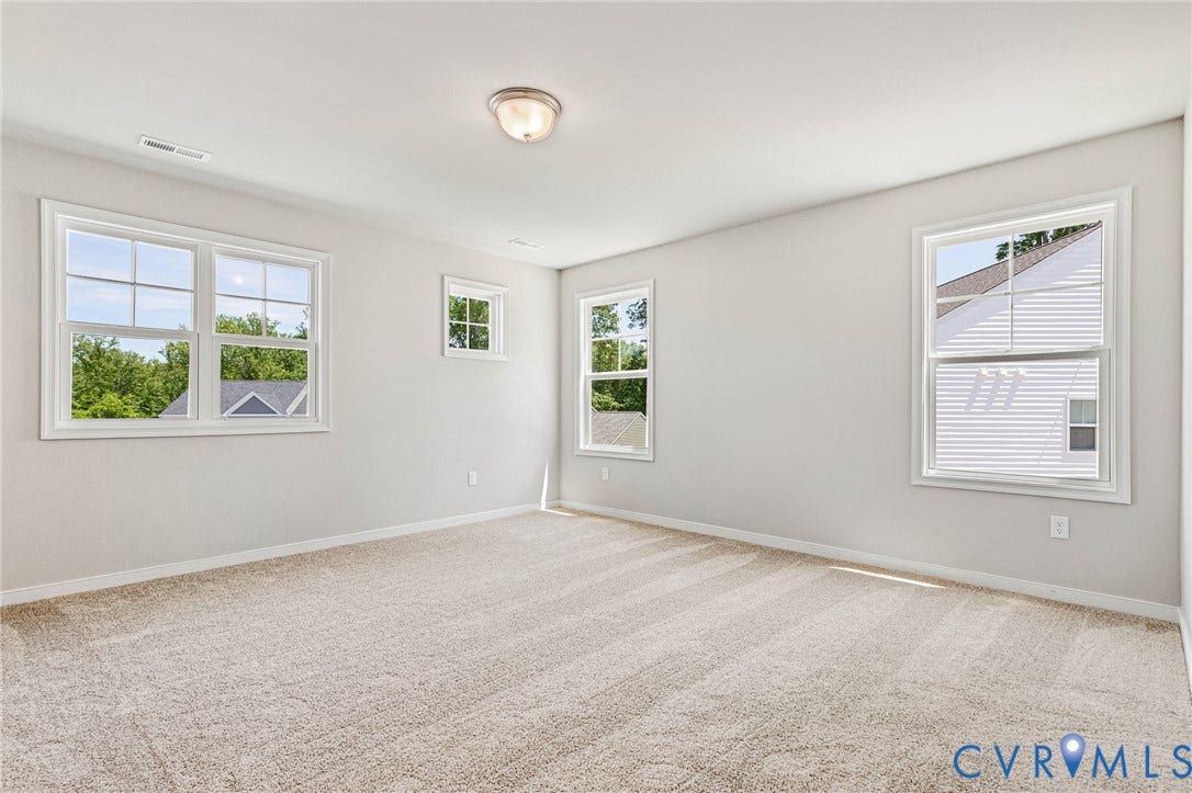 12606 Poplar Village Place, Poplar Village, Chester, VA 23831 Neutral tone carpeting with light-colored walls and multiple windows