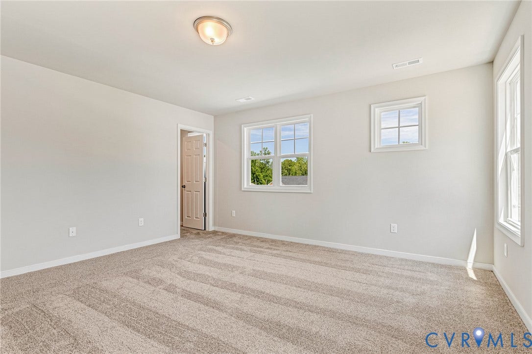 12606 Poplar Village Place, Poplar Village, Chester, VA 23831 Spacious room featuring neutral carpeting, light-colored walls, white trim, and multiple windows
