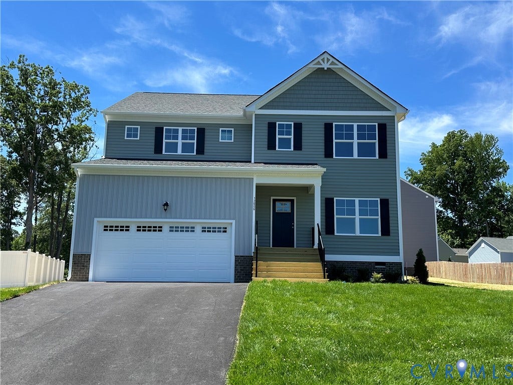 12606 Poplar Village Place, Poplar Village, Chester, VA 23831 Two-story residence featuring a partial brick facade, a two-car garage with an asphalt driveway, and a covered front entry with wooden steps