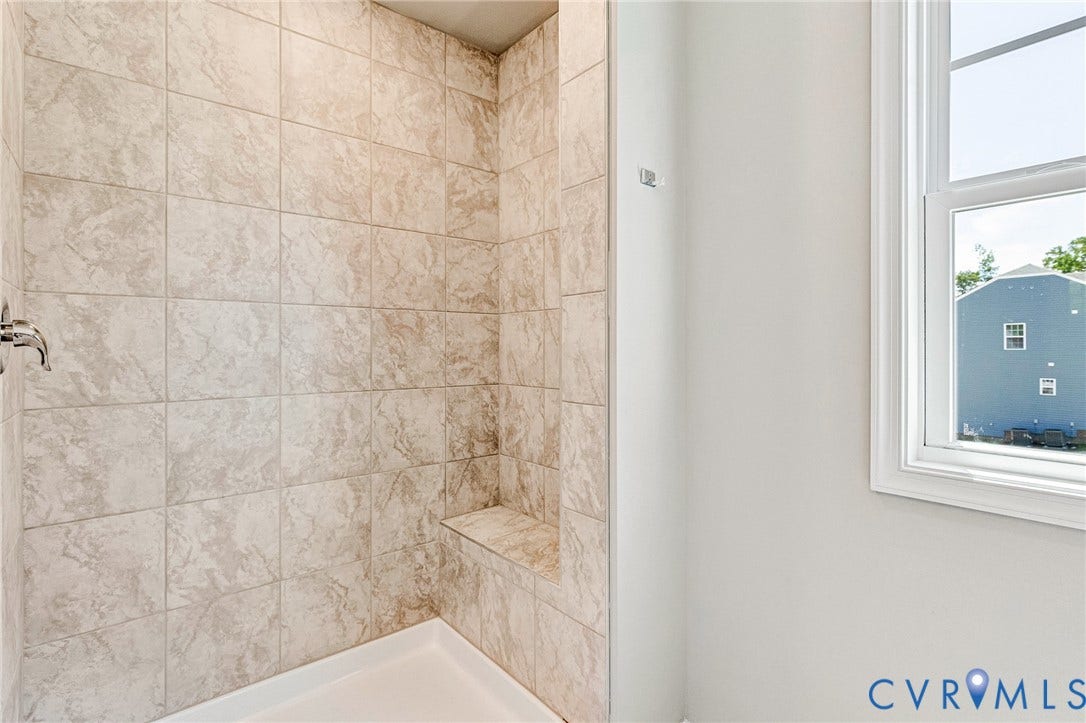 12606 Poplar Village Place, Poplar Village, Chester, VA 23831 Tiled shower enclosure featuring a built-in bench, chrome fixtures, and a white shower pan