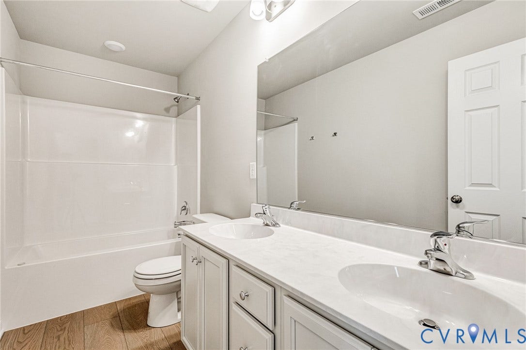 12606 Poplar Village Place, Poplar Village, Chester, VA 23831 Bathroom featuring a dual vanity with white cabinetry, integrated sinks, and chrome fixtures