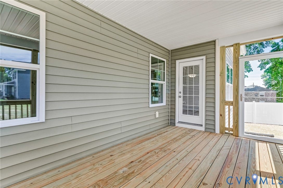 12606 Poplar Village Place, Poplar Village, Chester, VA 23831 Covered porch featuring natural wood flooring, light gray horizontal siding, and a white beadboard ceiling