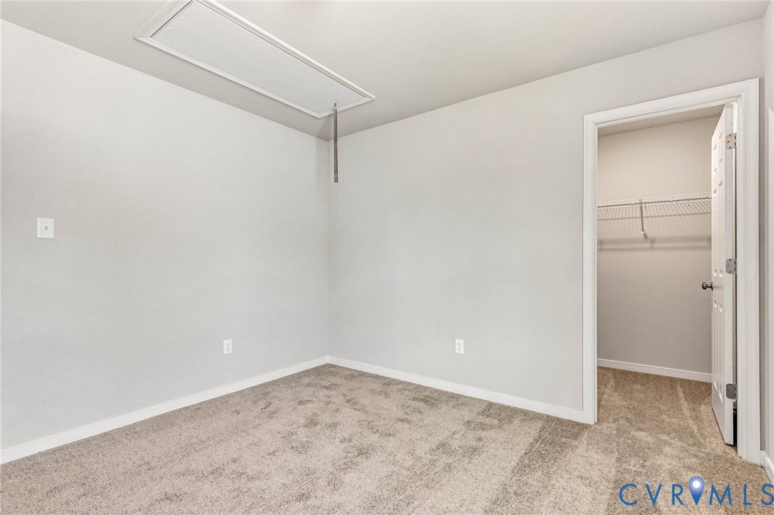 12606 Poplar Village Place, Poplar Village, Chester, VA 23831 Bedroom featuring light gray wall paint, neutral carpet flooring, white trim, and a closet with wire shelving