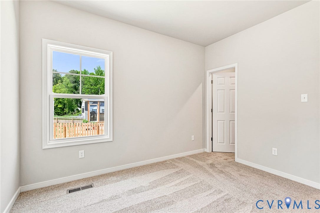 12606 Poplar Village Place, Poplar Village, Chester, VA 23831 Neutral wall paint, light-colored carpet flooring, white trim, and a white paneled door