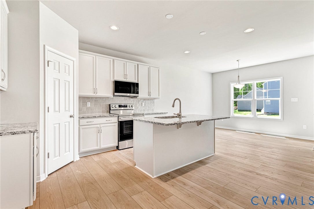 12606 Poplar Village Place, Poplar Village, Chester, VA 23831 Modern kitchen featuring white cabinetry, granite countertops, stainless steel appliances, a tiled backsplash, and wood-finish flooring