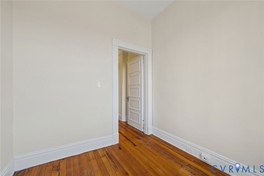 5 S Adams Street, Richmond, VA 23220 Unfurnished room with baseboards and hardwood / wood-style flooring