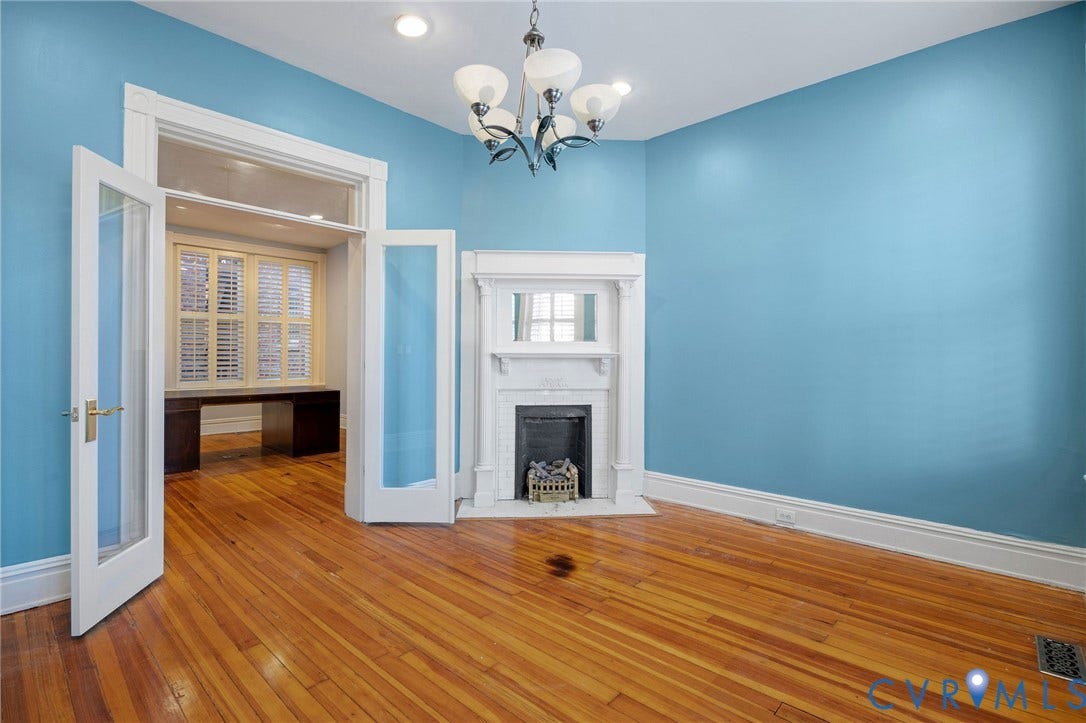 5 S Adams Street, Richmond, VA 23220 Unfurnished living room with hardwood / wood-style flooring, a brick fireplace, a chandelier, and recessed lighting