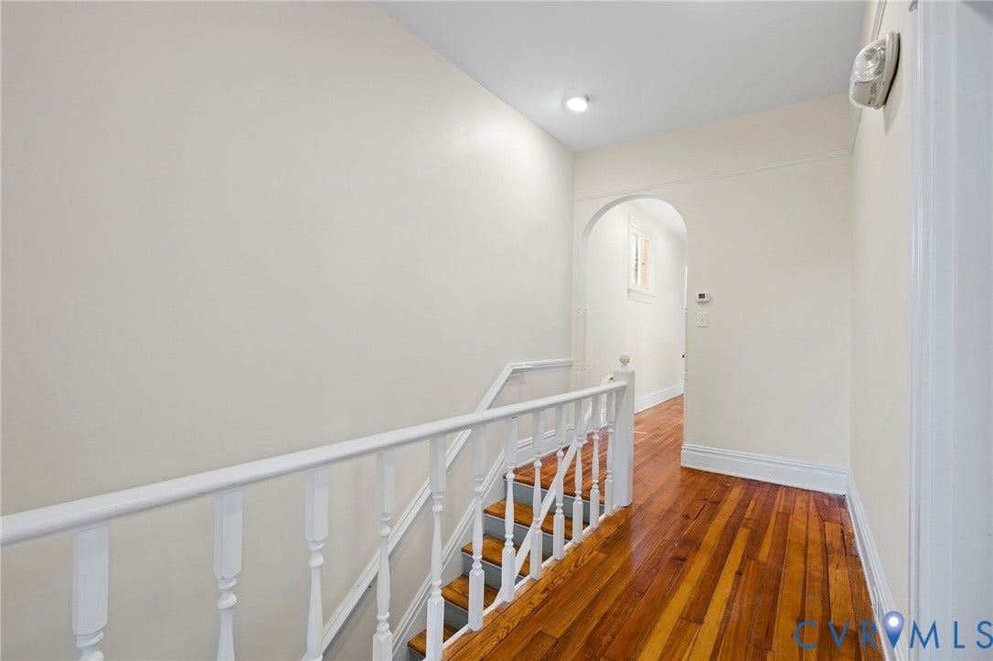 5 S Adams Street, Richmond, VA 23220 Corridor featuring an upstairs landing, arched walkways, and dark wood finished floors