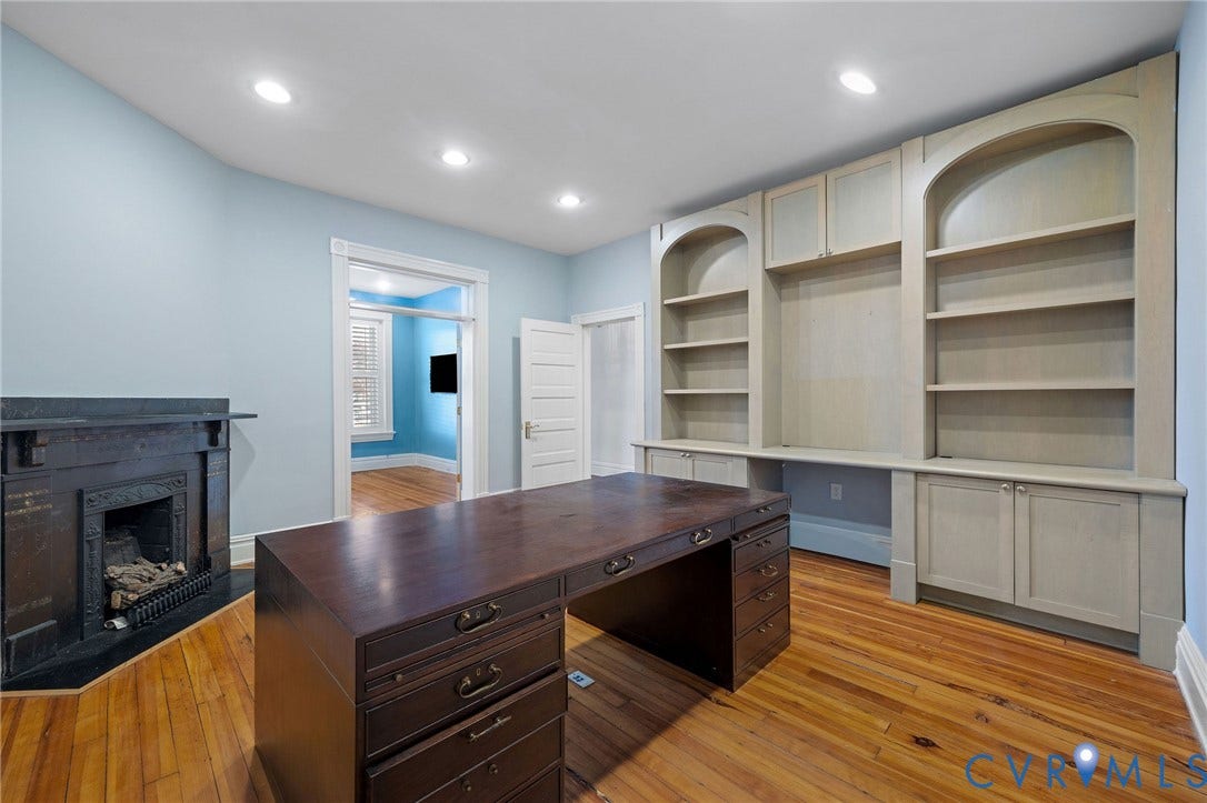 5 S Adams Street, Richmond, VA 23220 Unfurnished office featuring light wood finished floors, a fireplace, recessed lighting, built in shelves, and built in desk