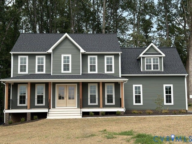 162 Bacon Bit Ln, Louisa, VA 23093 Classic two-story Colonial with gray fiber cement siding and white trim, featuring a front-gable roof with architectural shingles, a covered front porch with white columns and railings, and multi-pane double-hung windows throughout