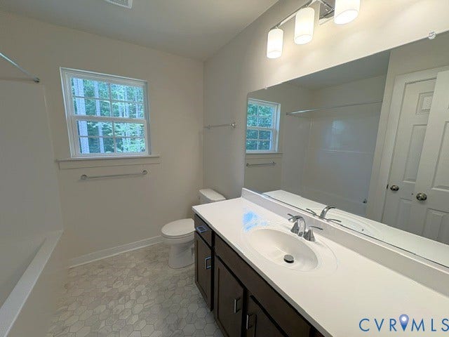 162 Bacon Bit Ln, Louisa, VA 23093 Spa-inspired primary bathroom featuring a double-sink vanity with dark cabinetry, white quartz countertop, and chrome fixtures