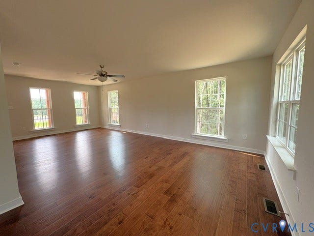 162 Bacon Bit Ln, Louisa, VA 23093 Expansive room featuring rich wood-finish flooring, multiple double-hung windows, a ceiling fan, and recessed lighting