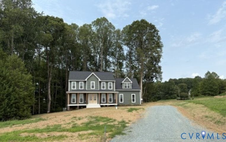 162 Bacon Bit Ln, Louisa, VA 23093 Charming Colonial-style residence featuring a two-story design with board-and-batten siding in slate blue, white trim detailing, and a covered front entry