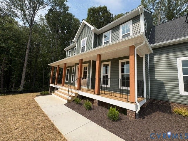 162 Bacon Bit Ln, Louisa, VA 23093 Siding exterior with white trim, covered porch, wood posts, black railings, and a concrete walkway