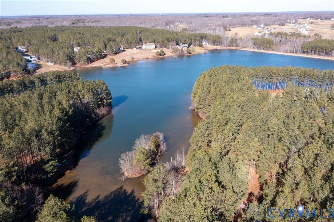 3739 Mill Mount Turn, Westlake At Mill Mount Sec2, Powhatan, VA 23139 Aerial overview of property's location with a nearby body of water and a heavily wooded area