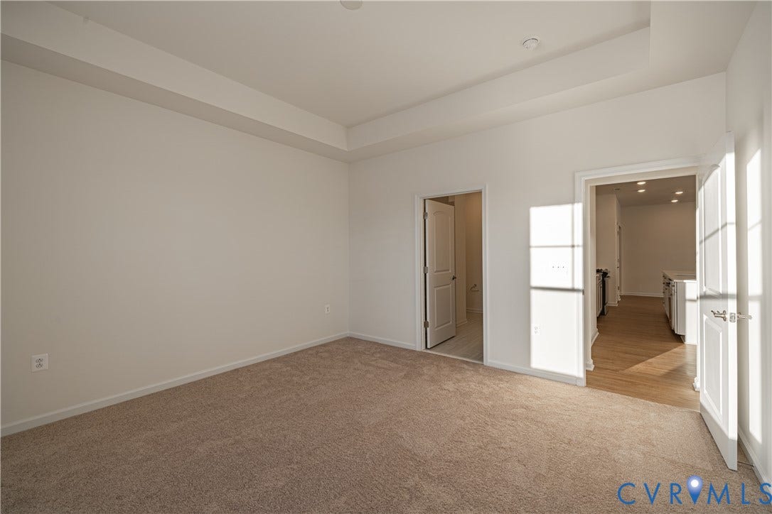 505 Bayberry Lane, Spring Creek, Zion Crossroads, VA 22942 Tucked at the back of the home is the FIRST-FLOOR primary suite featuring a spacious walk-in closet, a tray ceiling, and an ensuite LUXURY bath with a curbless walk-in shower and a double vanity.