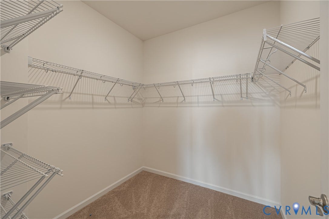 505 Bayberry Lane, Spring Creek, Zion Crossroads, VA 22942 Tucked at the back of the home is the FIRST-FLOOR primary suite featuring a spacious walk-in closet, a tray ceiling, and an ensuite LUXURY bath with a curbless walk-in shower and a double vanity.