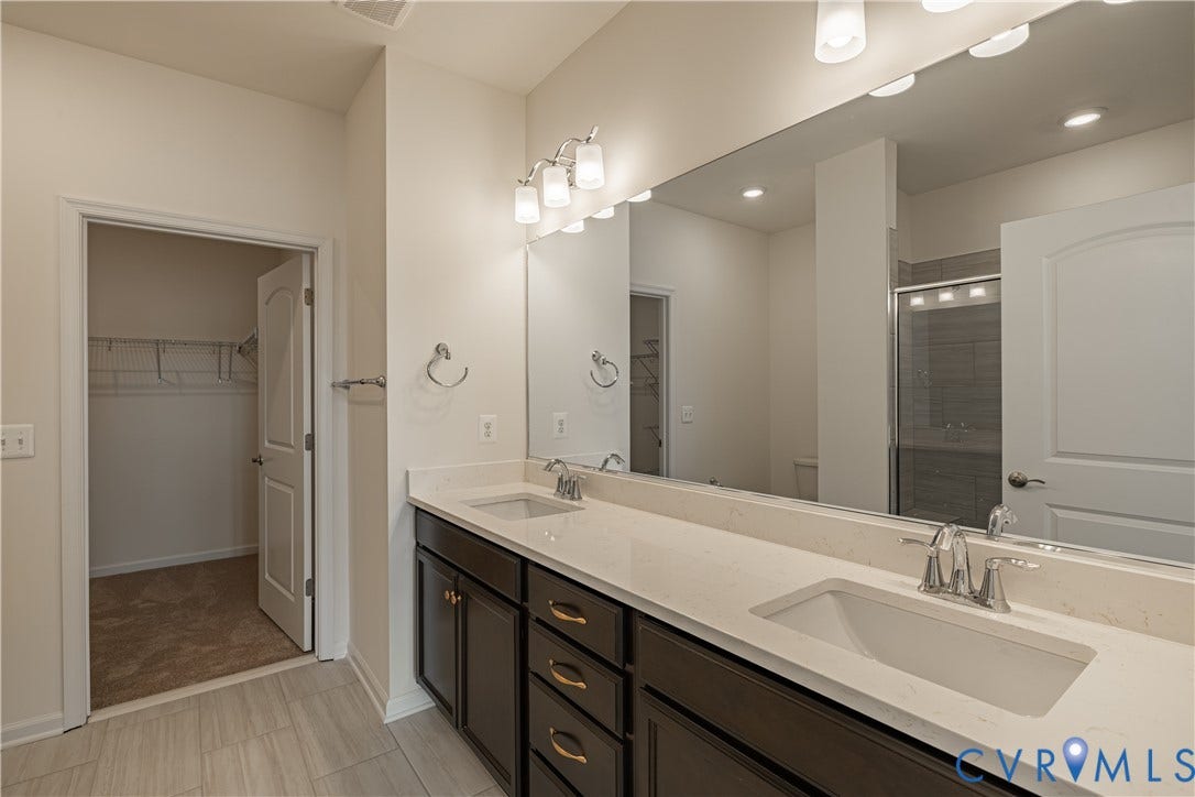 505 Bayberry Lane, Spring Creek, Zion Crossroads, VA 22942 Tucked at the back of the home is the FIRST-FLOOR primary suite featuring a spacious walk-in closet, a tray ceiling, and an ensuite LUXURY bath with a curbless walk-in shower and a double vanity.