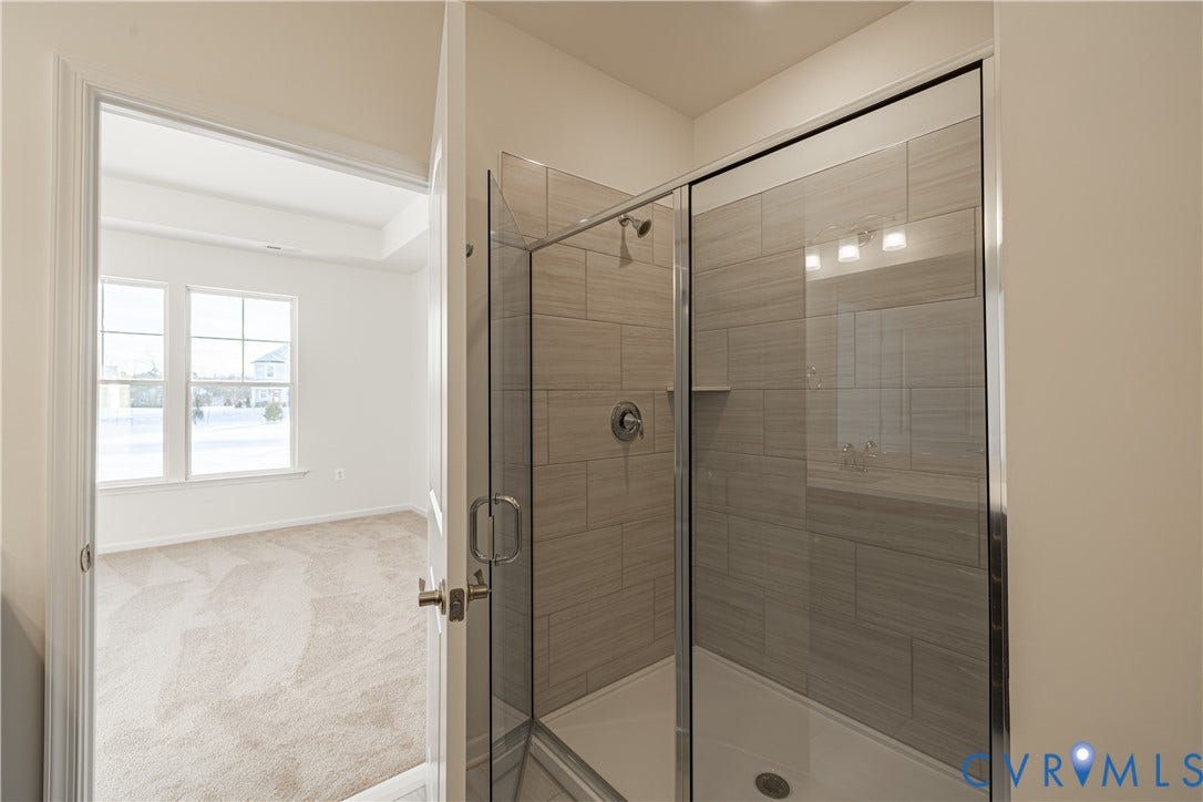 505 Bayberry Lane, Spring Creek, Zion Crossroads, VA 22942 Tucked at the back of the home is the FIRST-FLOOR primary suite featuring a spacious walk-in closet, a tray ceiling, and an ensuite LUXURY bath with a curbless walk-in shower and a double vanity.