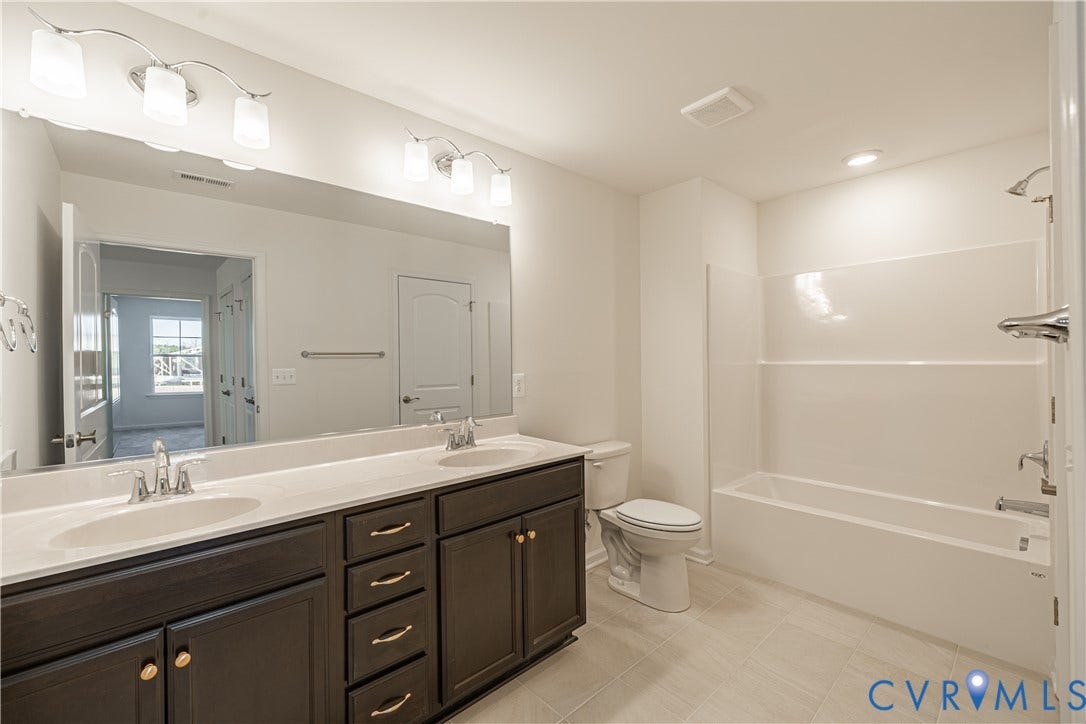 505 Bayberry Lane, Spring Creek, Zion Crossroads, VA 22942 Bedroom two, featuring a walk-in closet, and bedroom three, offering a spacious double-door closet, share a full hall bath with a tub/shower combo.