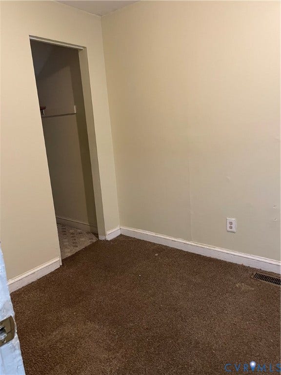 712 W Washington Street, #B, Petersburg, VA 23803 Unfurnished bedroom featuring dark carpet and baseboards