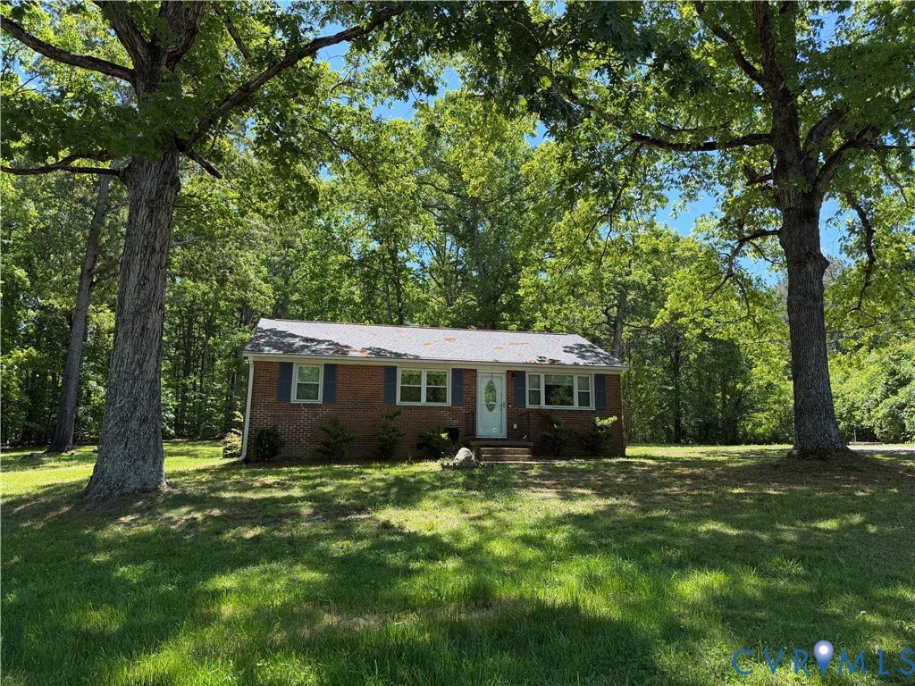 1611 Anderson Highway, Powhatan, VA 23139 Brick ranch-style home featuring a white entry door, multiple windows with dark shutters, and a light-colored roof