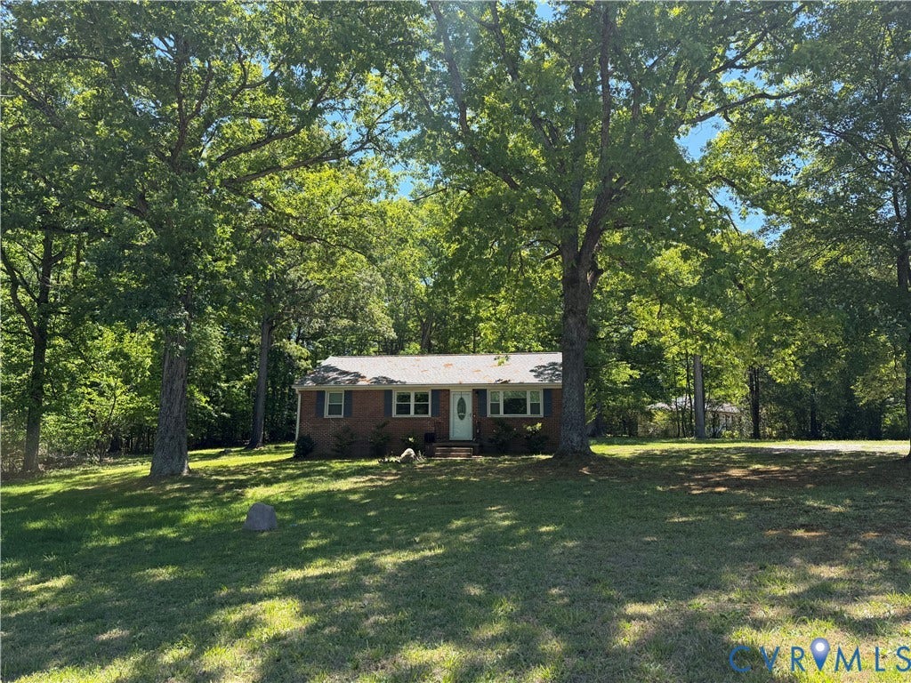 1611 Anderson Highway, Powhatan, VA 23139 Brick ranch-style home featuring a white front door and surrounding natural landscaping