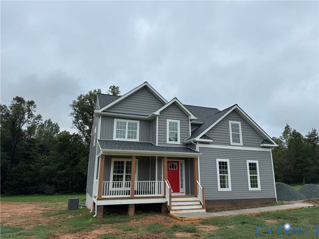248 Bannister Town Road, Louisa, VA 23093 Gray exterior siding, red front door, white porch railing, exposed wood porch columns, and a dark shingle roof