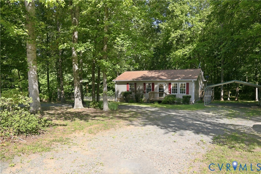 1637 Gardners Road, Mineral, Mineral, VA 23117 Single-story residence featuring a gray exterior with red window shutters, a front porch with natural wood railings, and a gravel driveway