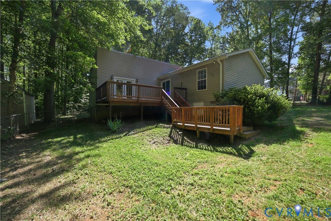 1637 Gardners Road, Mineral, Mineral, VA 23117 Rear exterior featuring a multi-level wood deck, light-colored siding, and mature trees providing natural screening