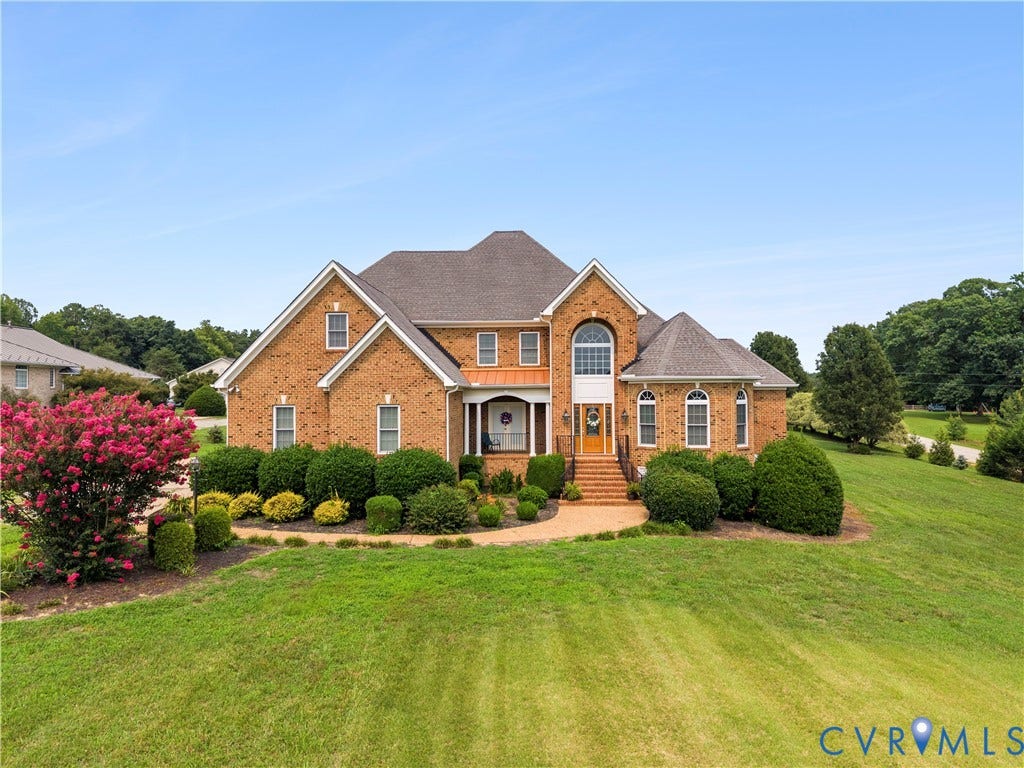 270 Petersburg Road, 4.34 Acre Lot - No Hoa, Powhatan, VA 23139 Traditional brick residence featuring a prominent arched window, symmetrical gables, a covered entry, and a mature landscaped front yard with a blooming tree
