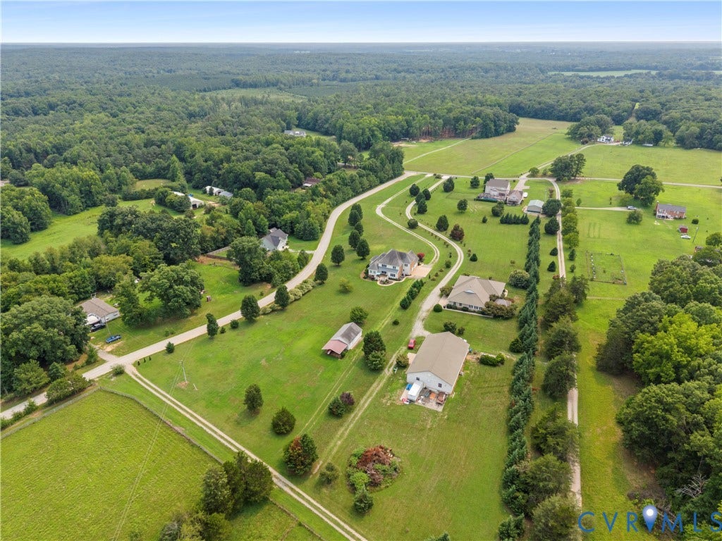 270 Petersburg Road, 4.34 Acre Lot - No Hoa, Powhatan, VA 23139 Expansive rural landscape featuring multiple residences, lush green lawns, mature trees, open fields, and paved driveways