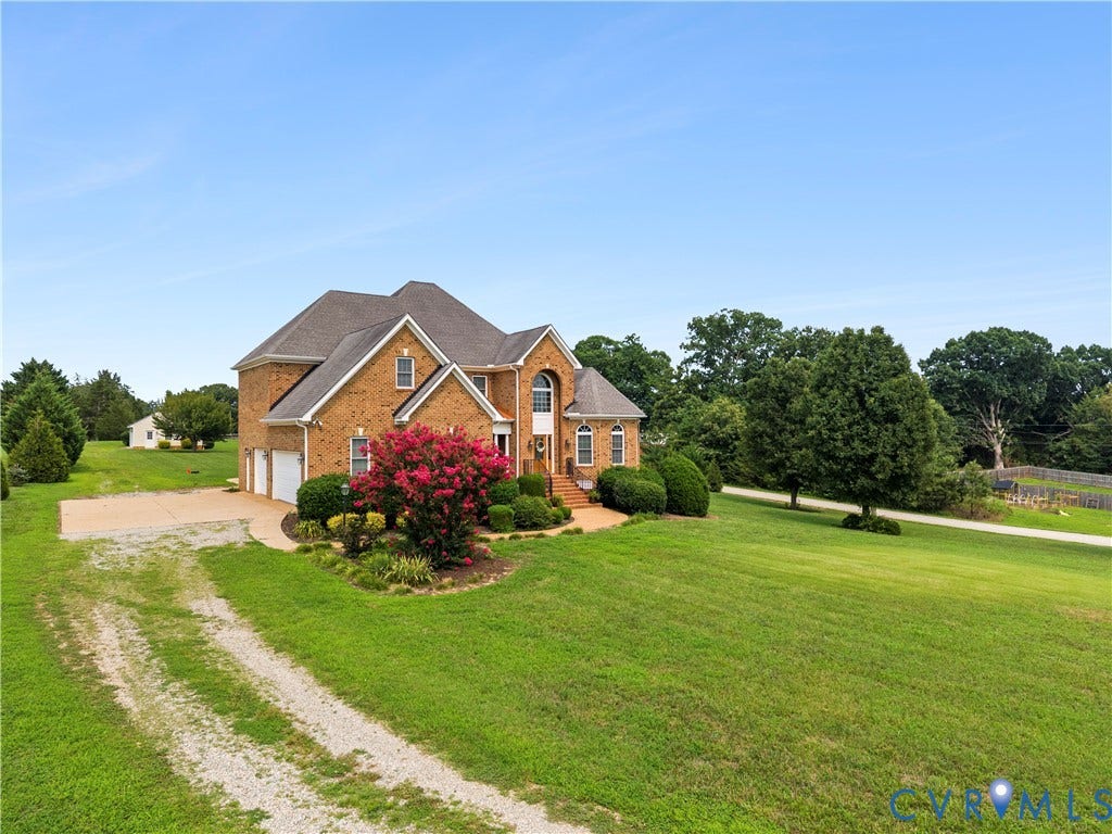 270 Petersburg Road, 4.34 Acre Lot - No Hoa, Powhatan, VA 23139 Traditional brick exterior featuring a two-car garage, established landscaping, and a broad gravel driveway