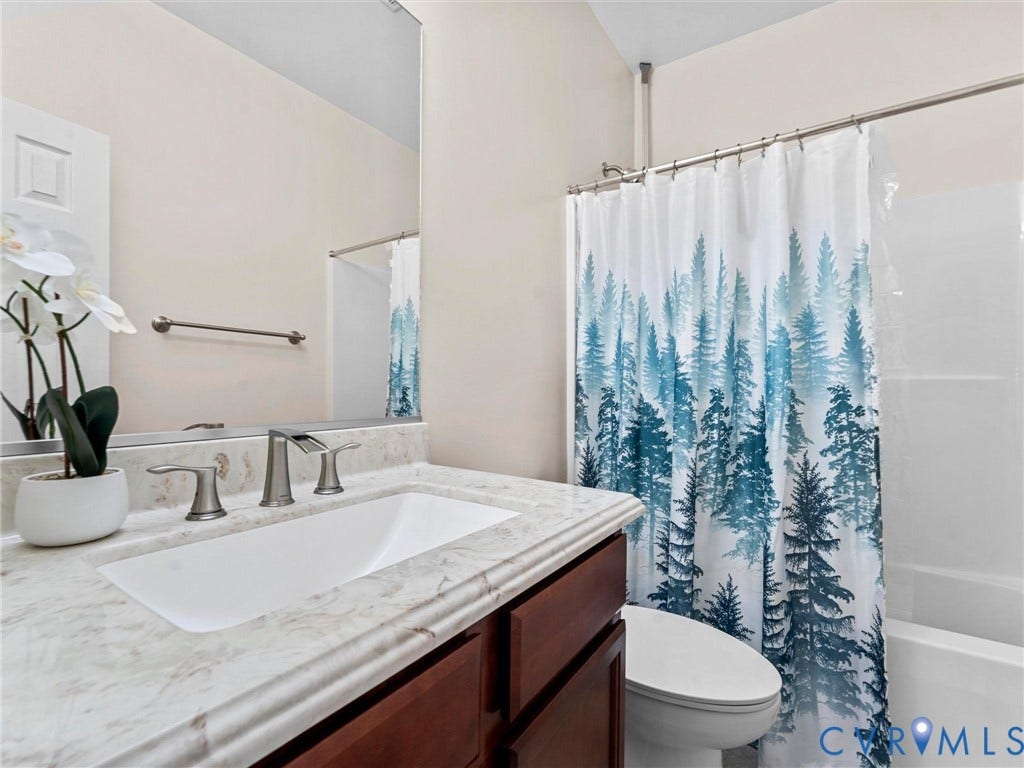 Full guest bath located between bedroom 2 & bedroom 3.